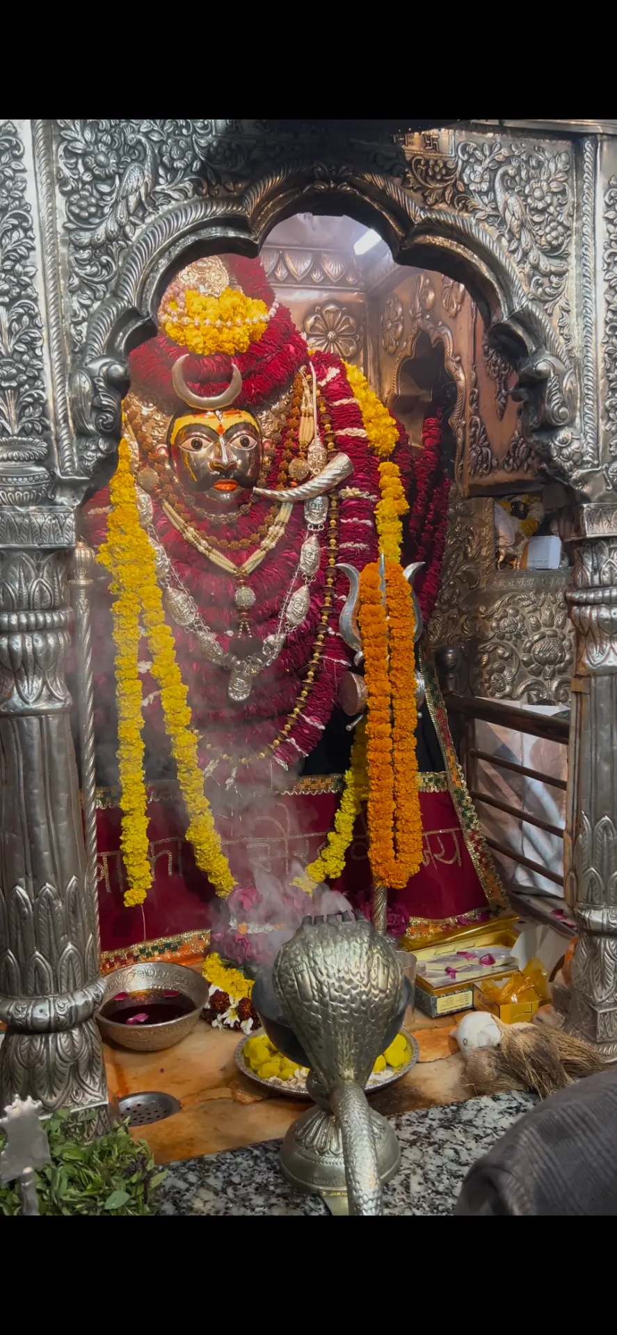 Kaal Bhairav shrine in silver, wrapped in marigold garlands
